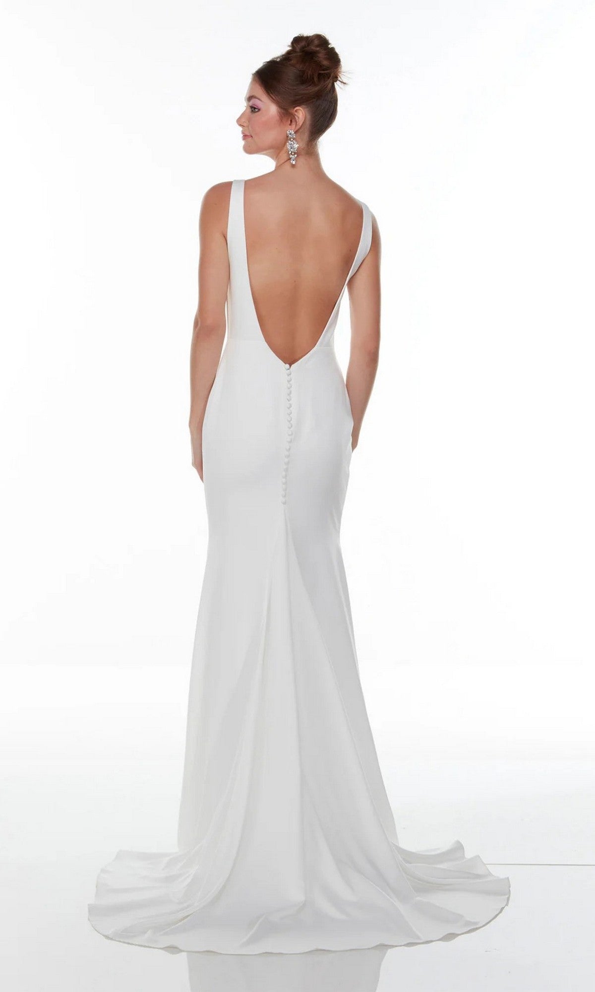 A modern bride wears the Alyce 7052, a floor-length, sleeveless white gown with a low back, button detailing, and an elegant train, set against a plain white background.